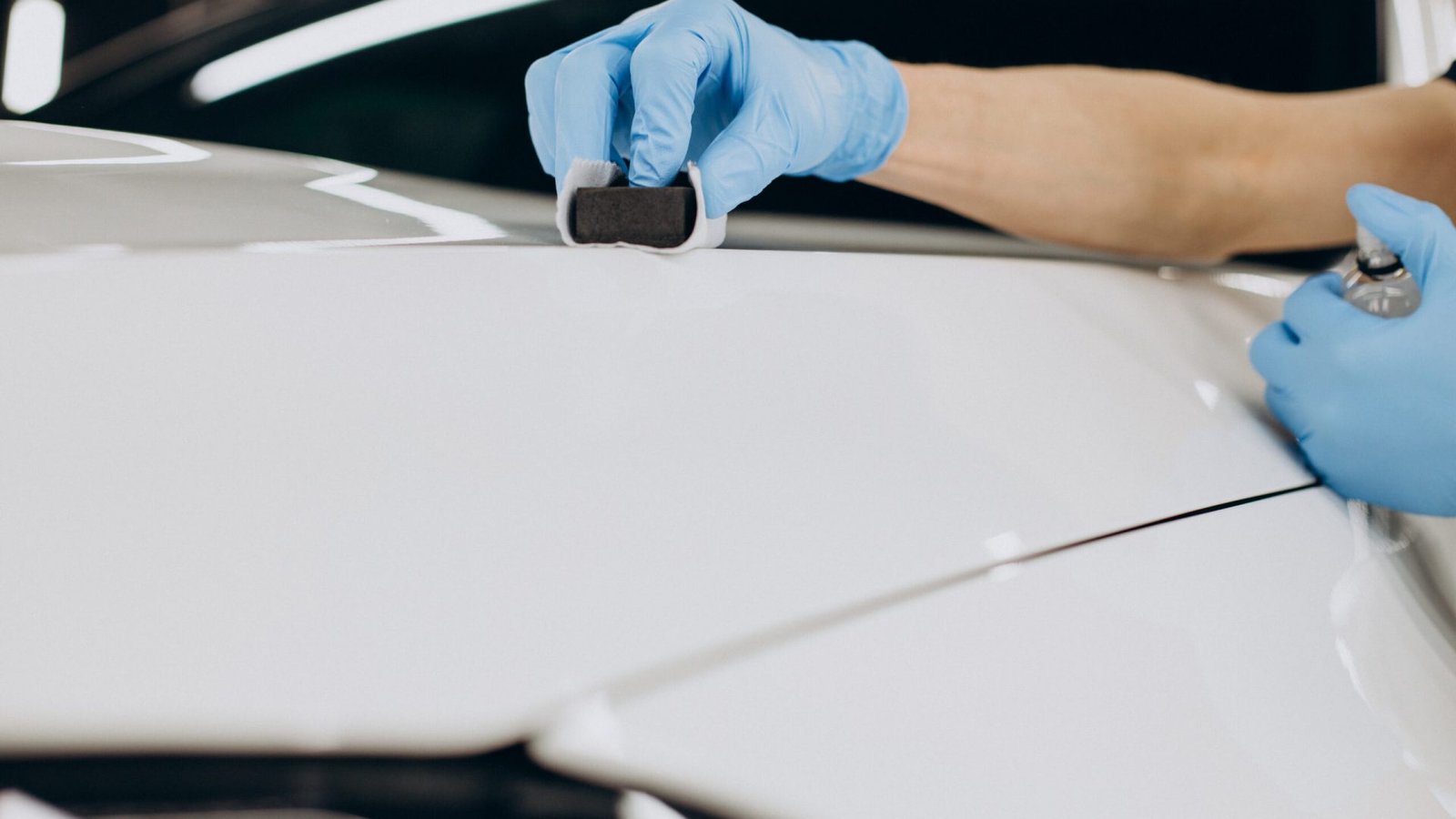 Man working car detailing and coating car